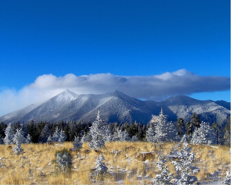 Snow-covered mountains under blue sky