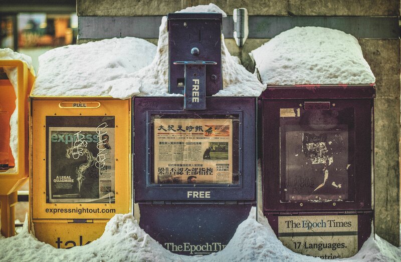 Snow-covered newspaper boxes