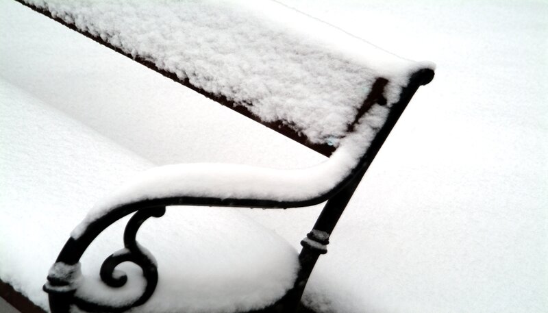 Snow-covered park bench