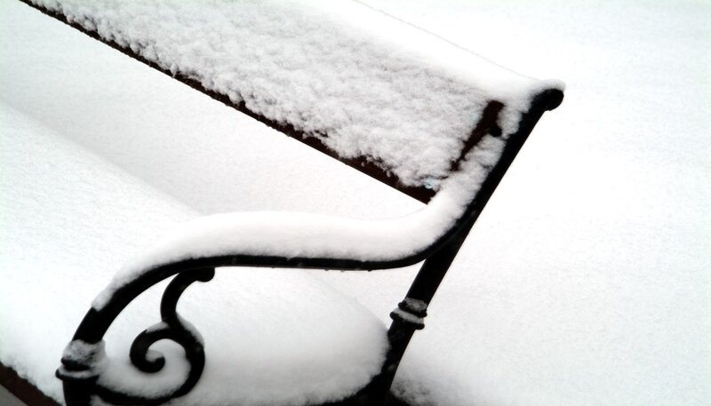 Snow-covered park bench