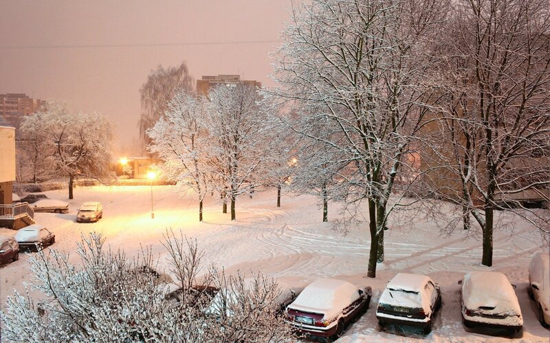 snow-covered parking lot at night