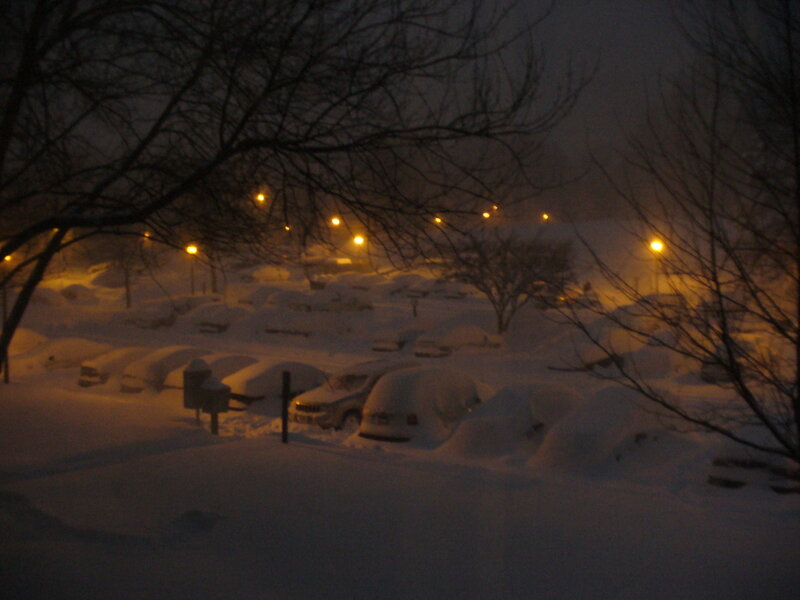 snow-covered parking lot at night