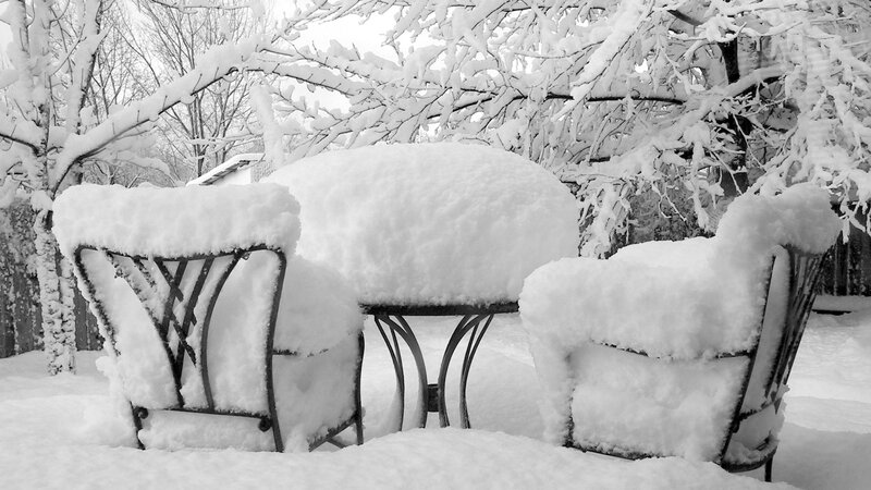 Snow-covered patio furniture