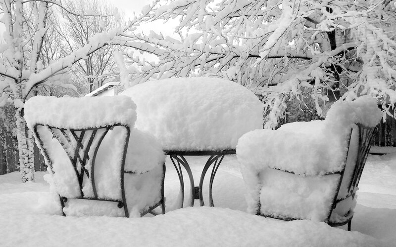 Snow-covered patio furniture
