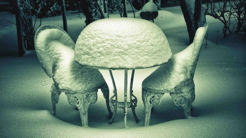 Snow-covered patio furniture