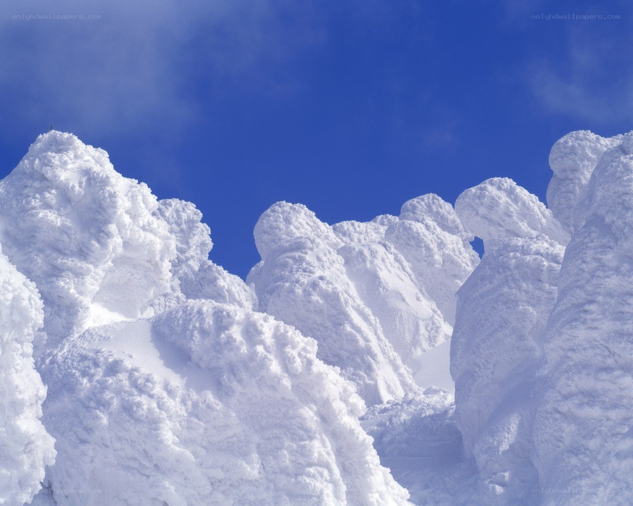 Snow-covered peaks under blue sky