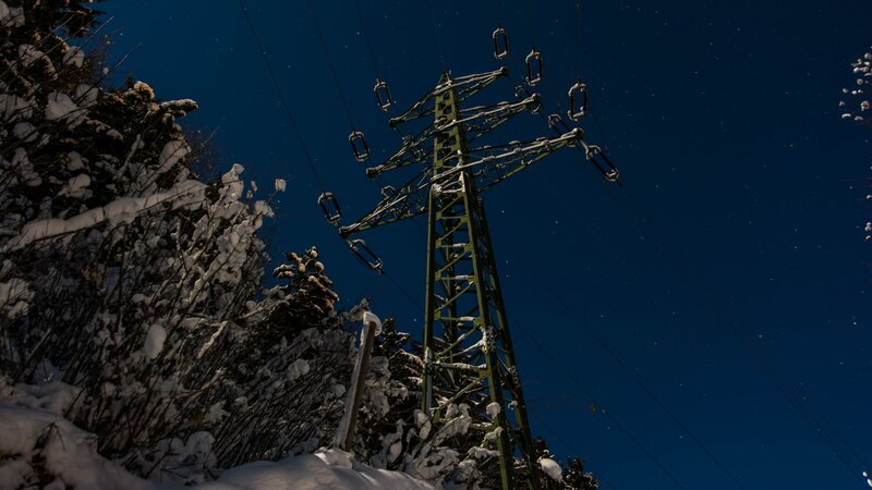 Snow-covered Power Line Tower