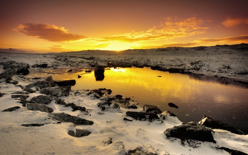Snow-covered River at Sunset