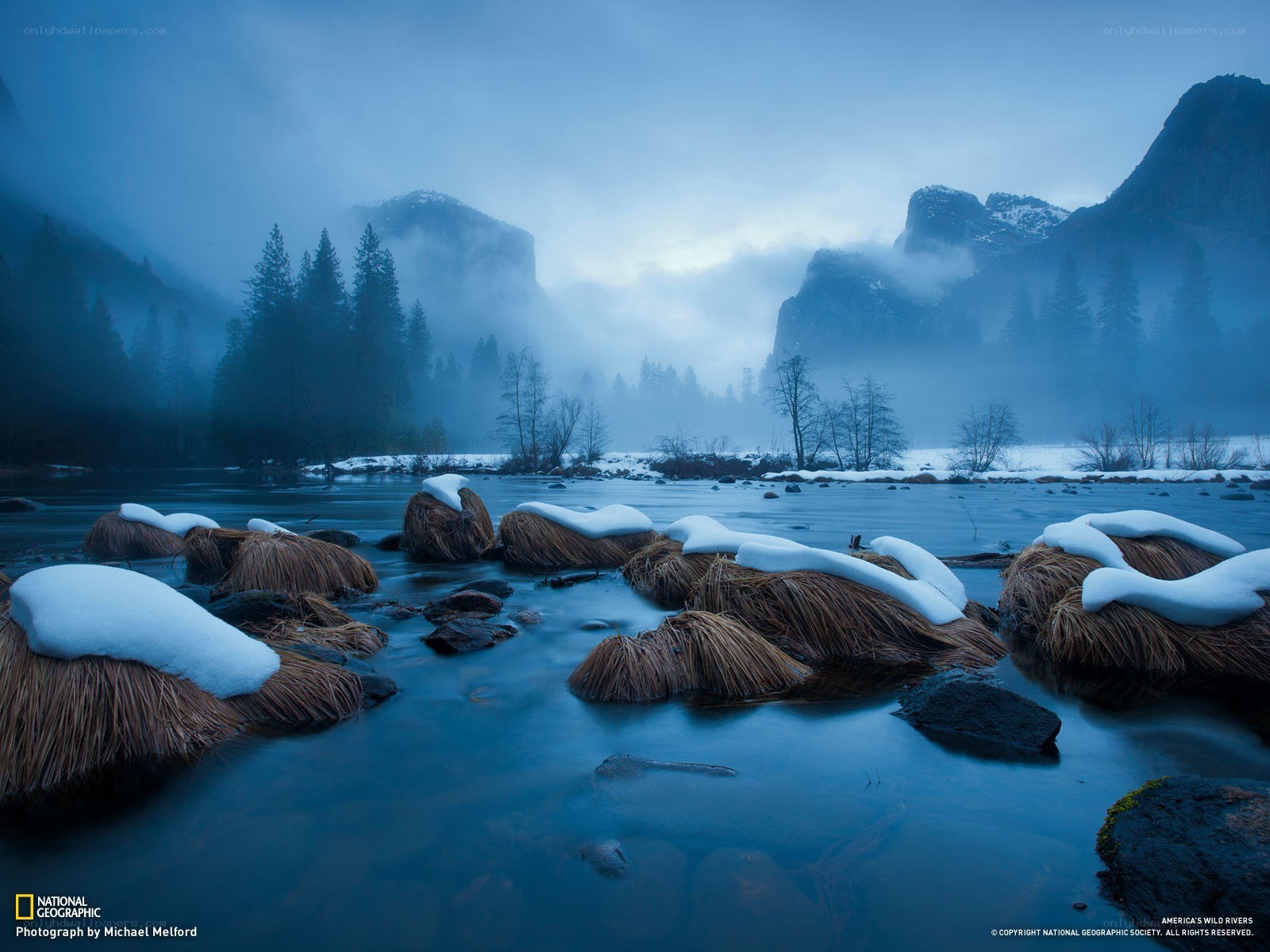 Snow-Covered River in a Misty Valley