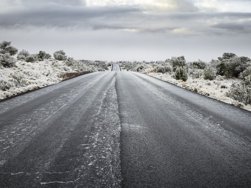 Snow-covered road in desert
