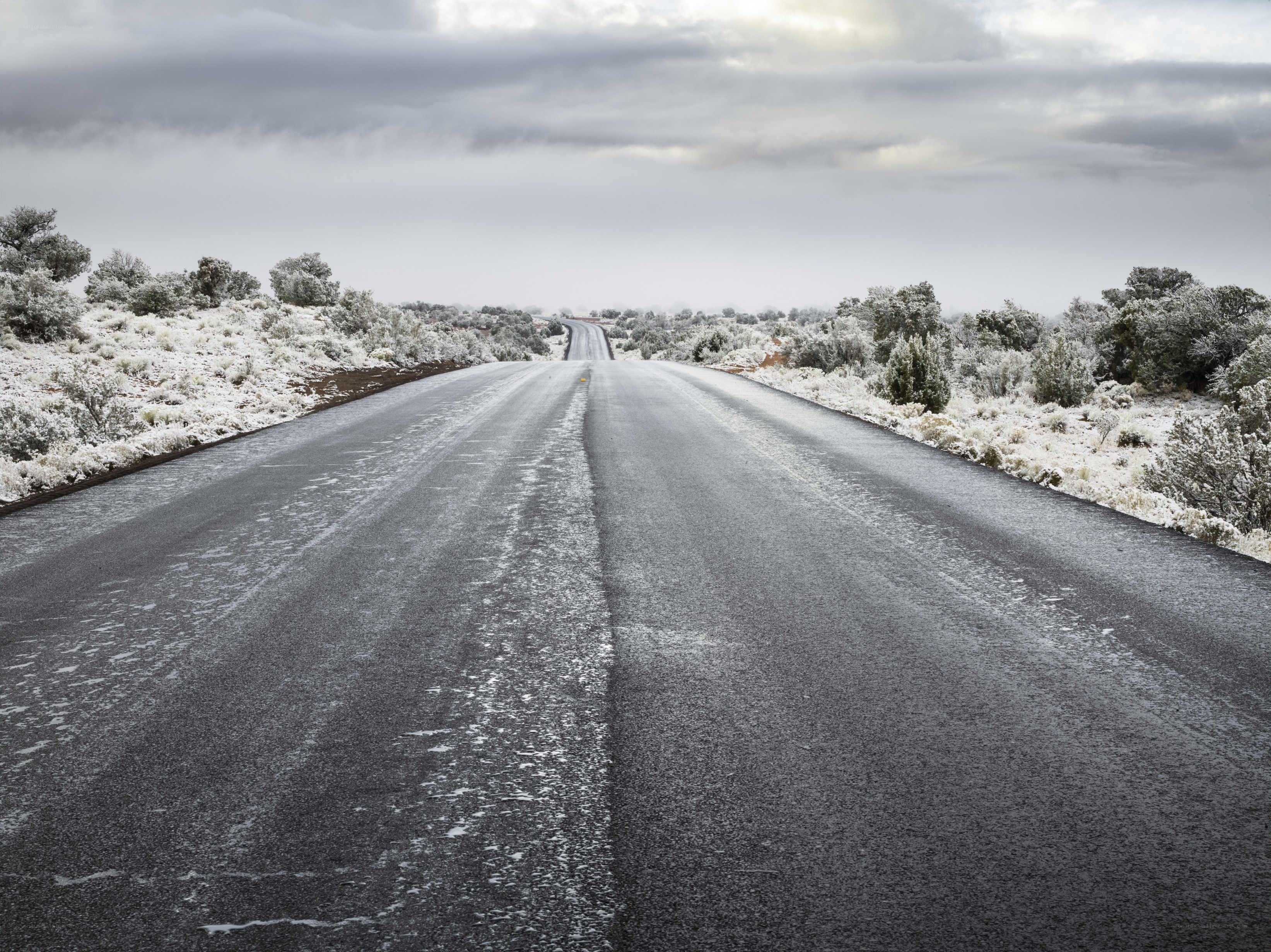 Snow-covered road in desert