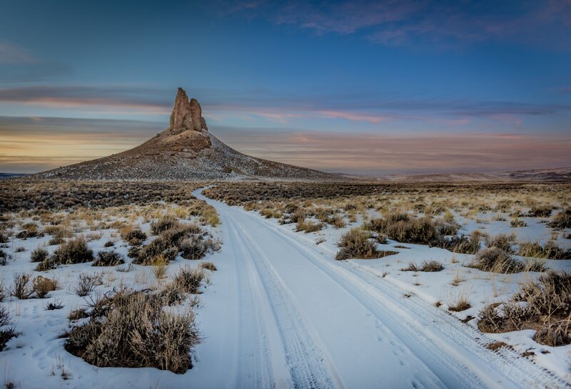 Snow-covered Road to Rock Formation — White
