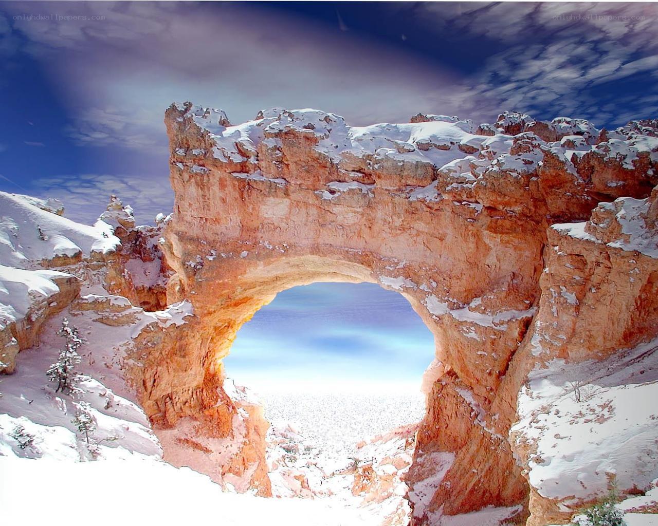 Snow-covered rock arch in canyon