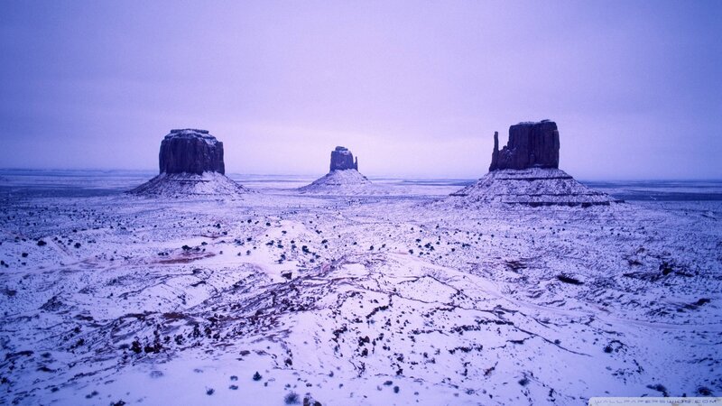 Snow-covered rock formations in desert