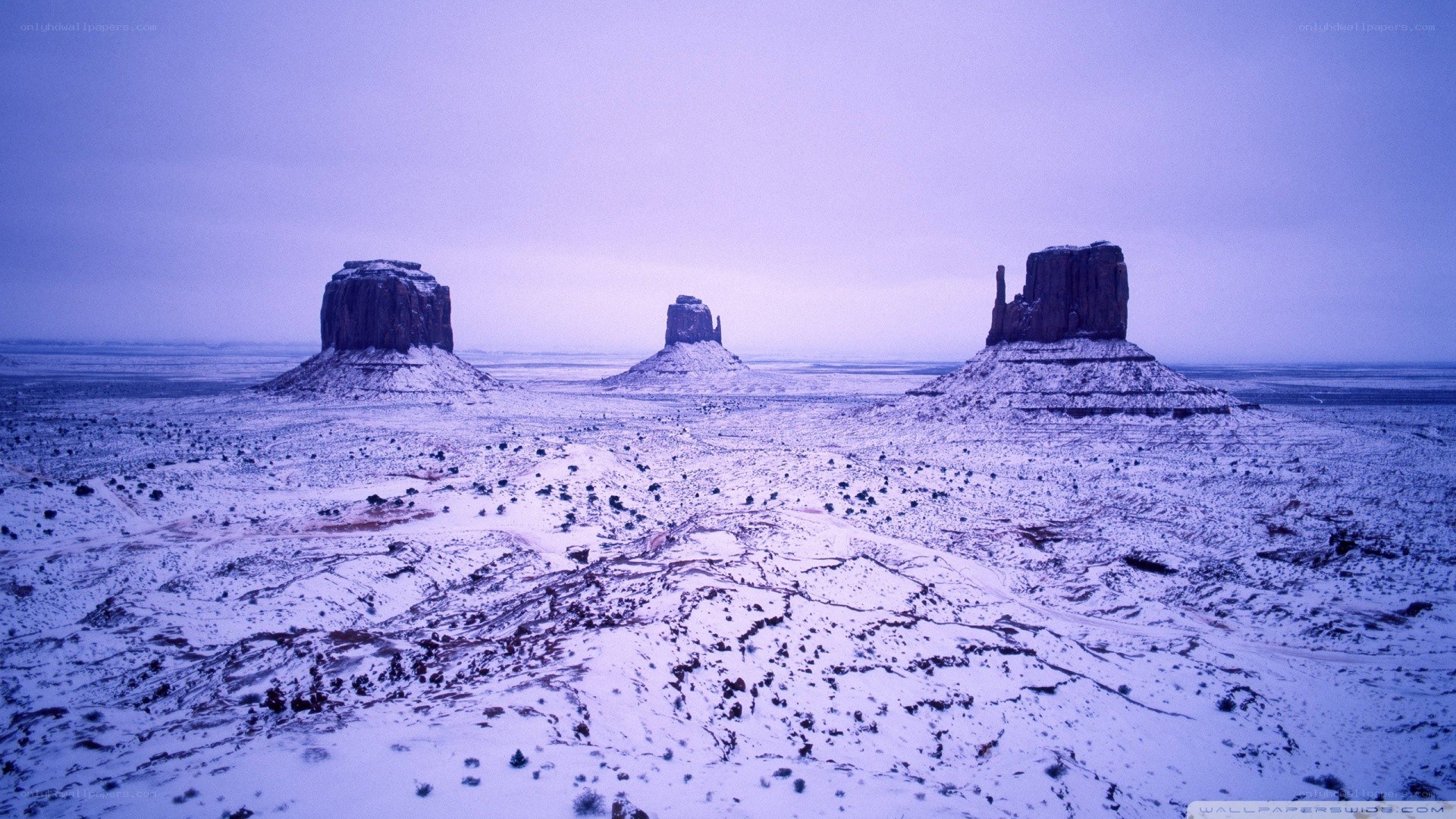 Snow-covered rock formations in desert