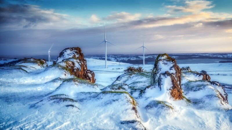 Snow-covered Rocks and Wind Turbines