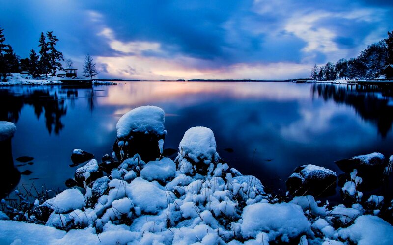 Snow-covered Rocks by Lake