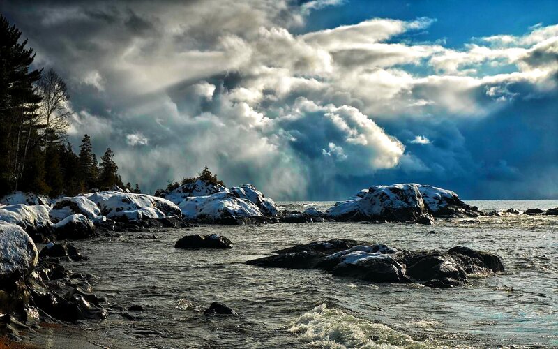 Snow-covered Rocks by Water — Blue