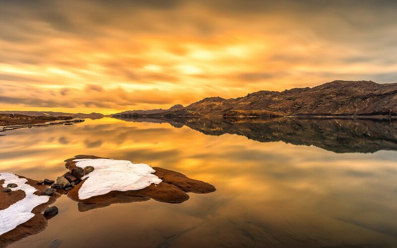 Snow-covered Rocks in Lake — Gold