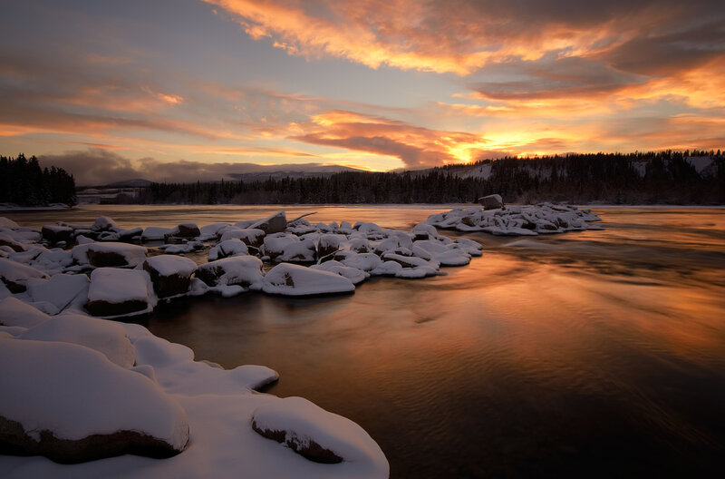 Snow-covered Rocks in River — Orange