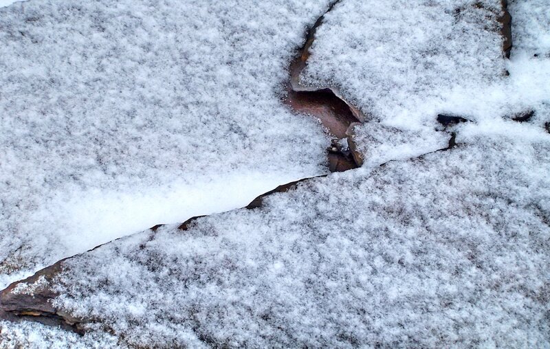 Snow-covered rocks with cracks
