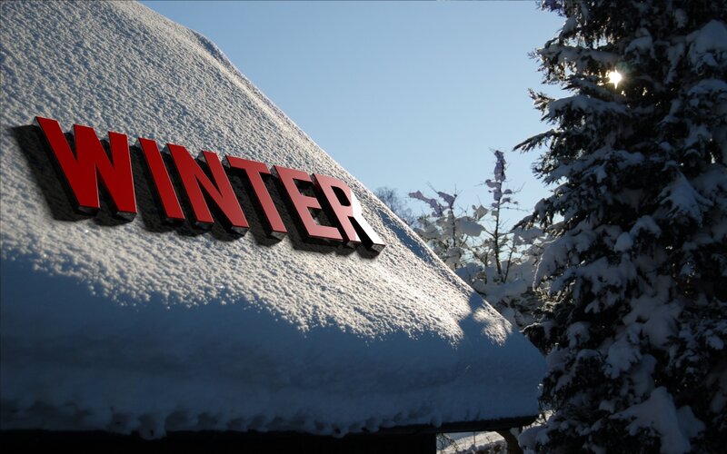 Snow-covered Roof with Sign
