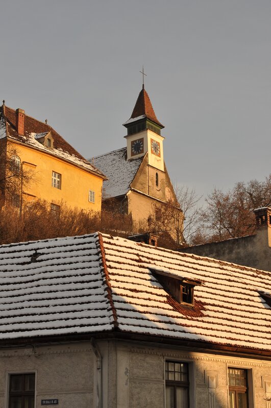 Snow-covered rooftops and church tower