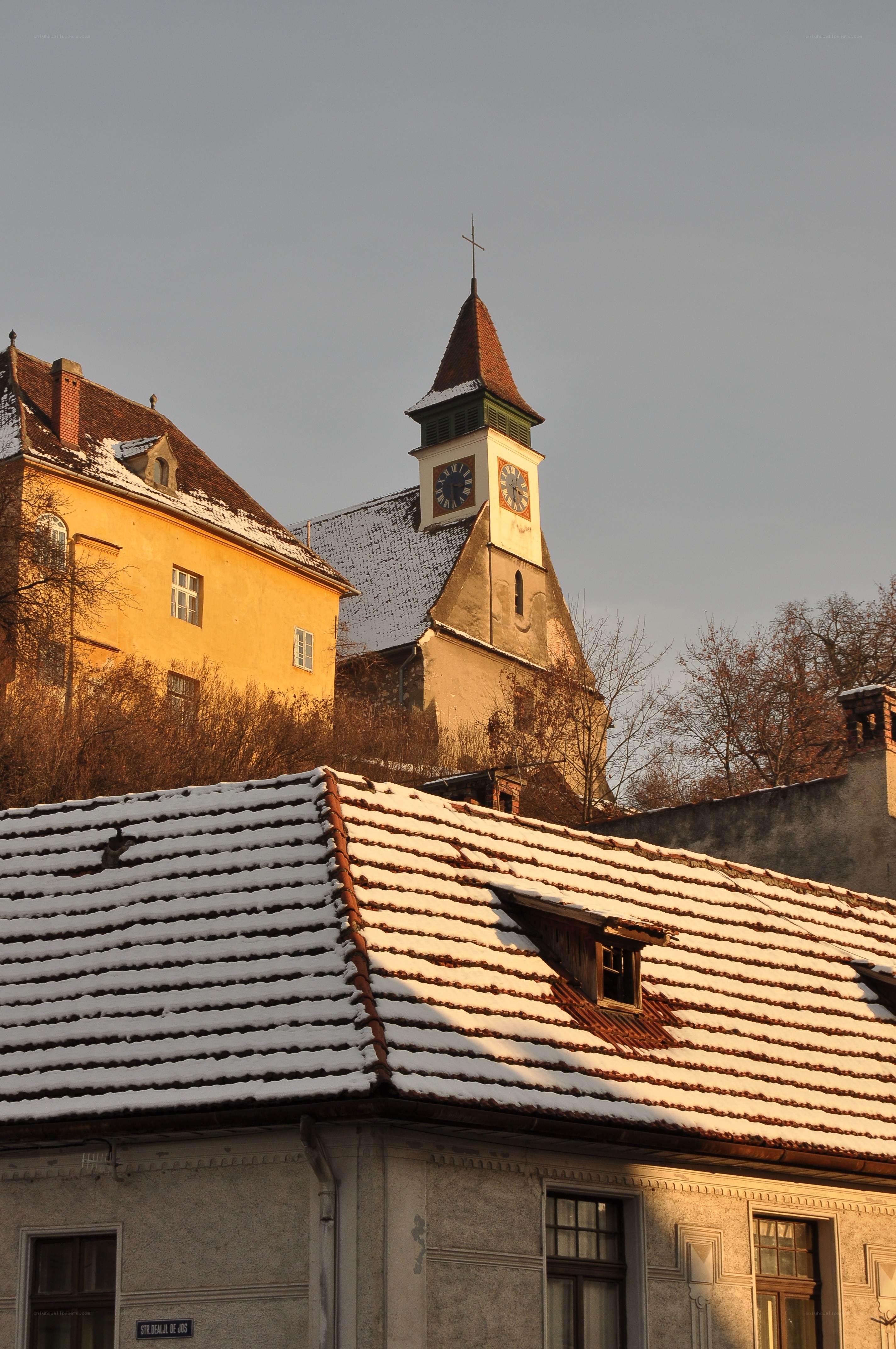Snow-covered rooftops and church tower