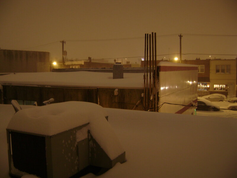 snow-covered rooftops at night