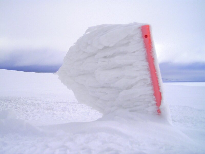 snow-covered shovel in winter