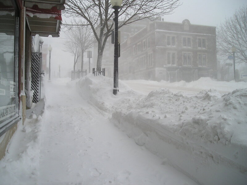 Snow-covered sidewalk during blizzard