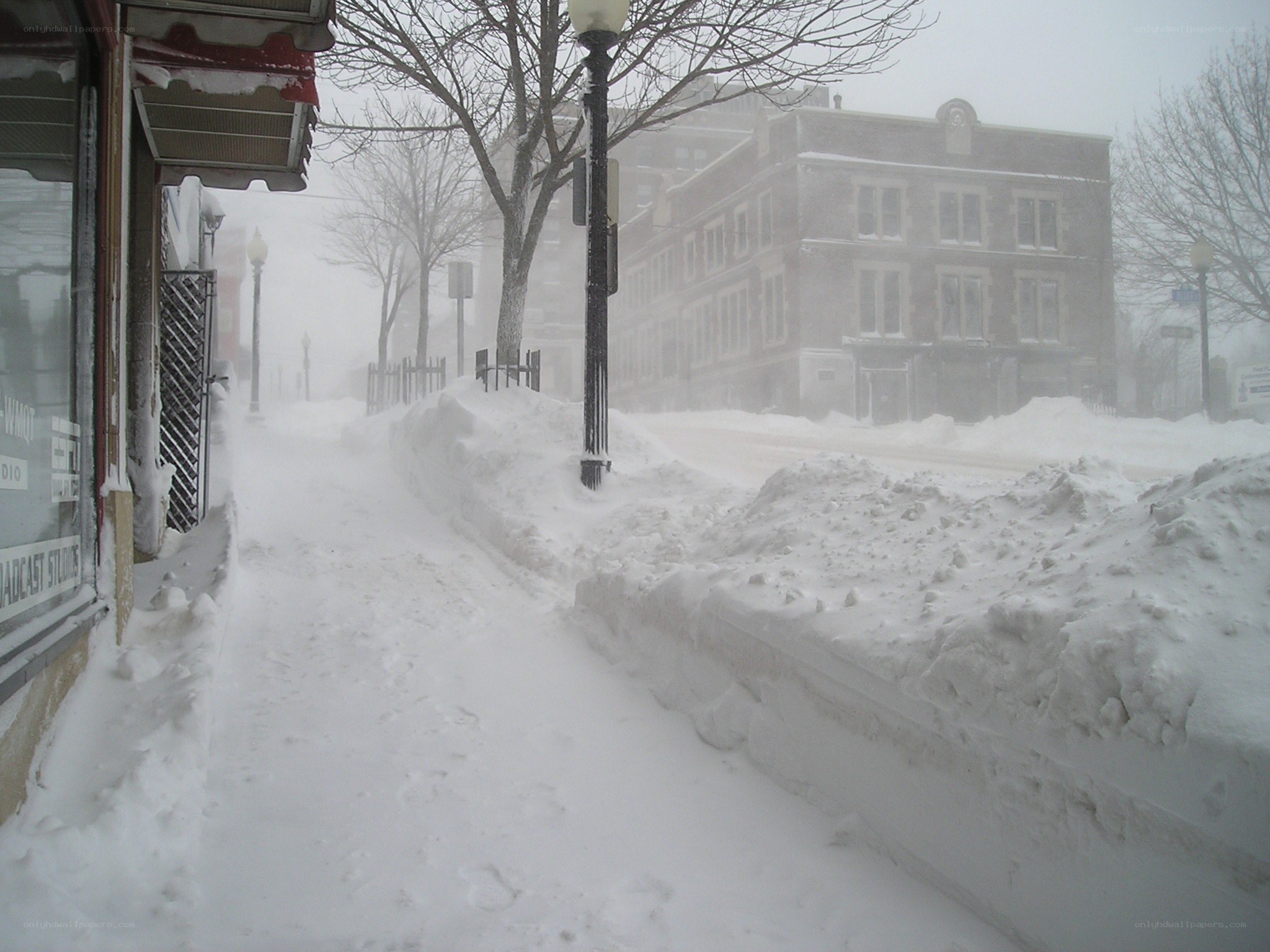 Snow-covered sidewalk during blizzard