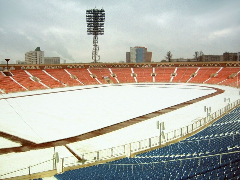 snow-covered stadium with red and blue seats