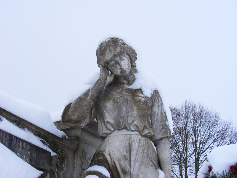 Snow-covered statue in winter