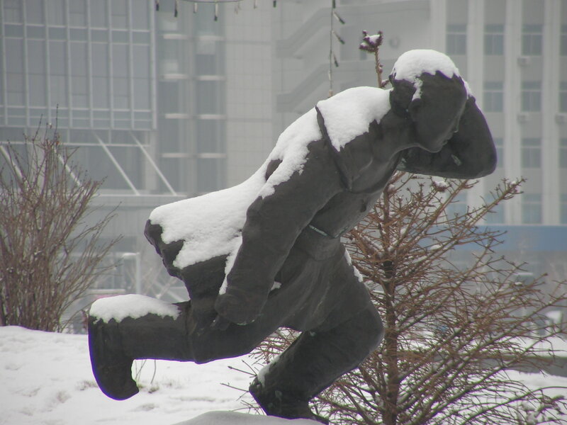 Snow-covered statue in winter