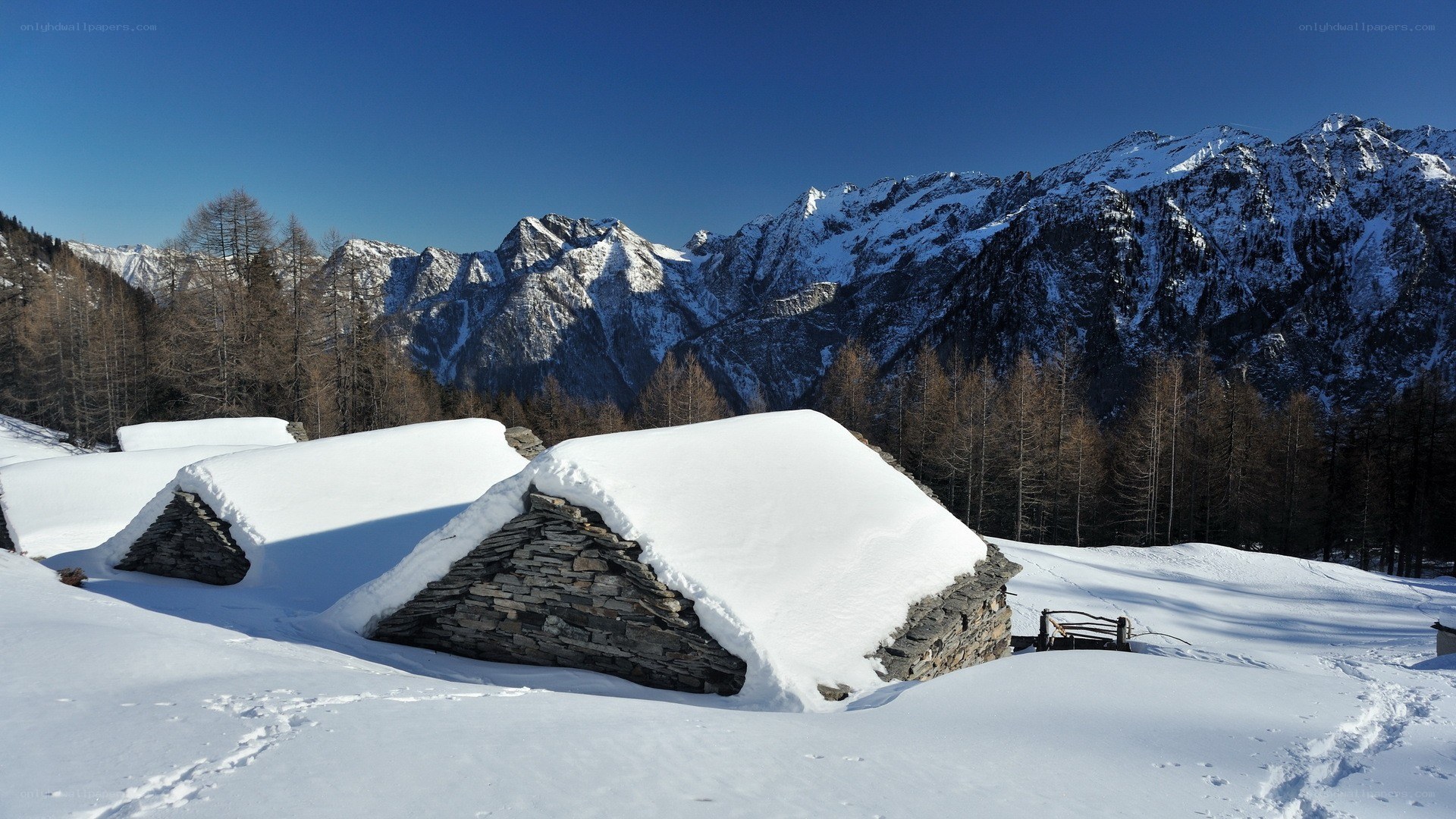 Snow-covered stone huts in mountains
