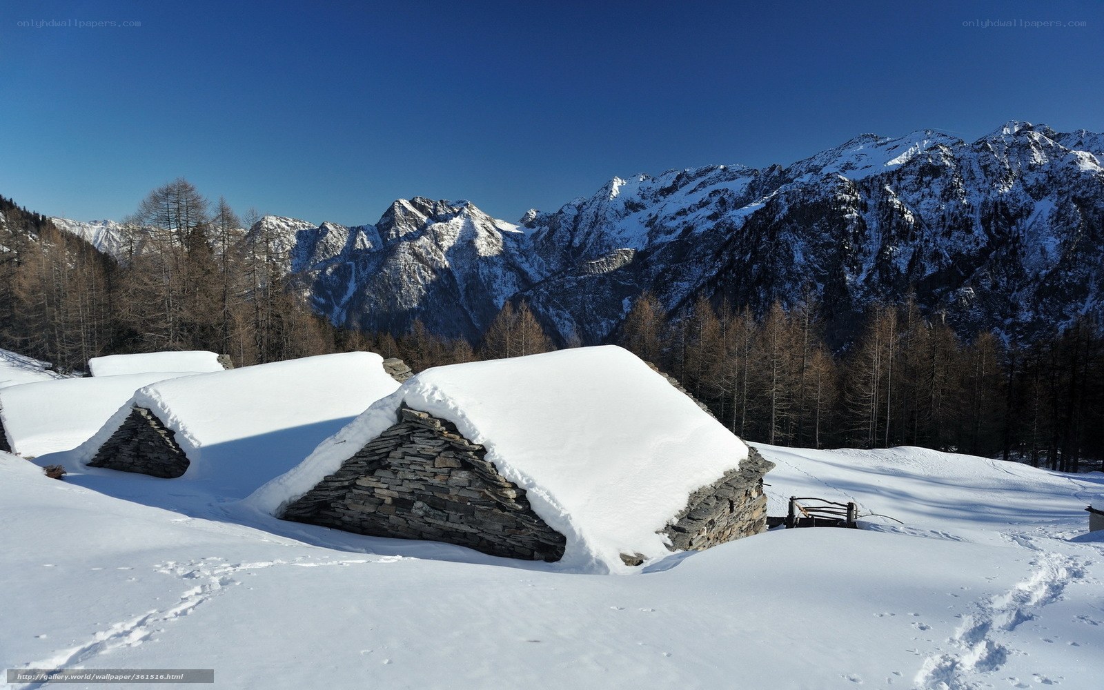 Snow-covered stone huts in mountains