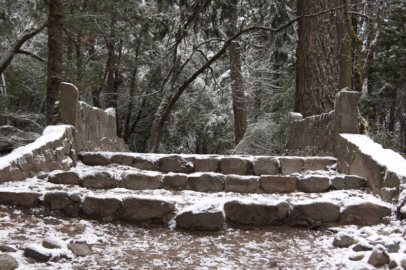 Snow-covered stone steps in forest