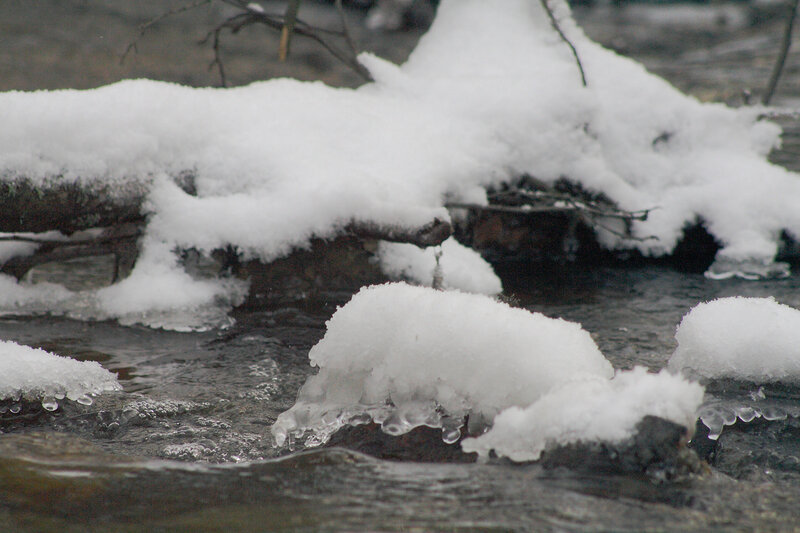 snow-covered stream in winter