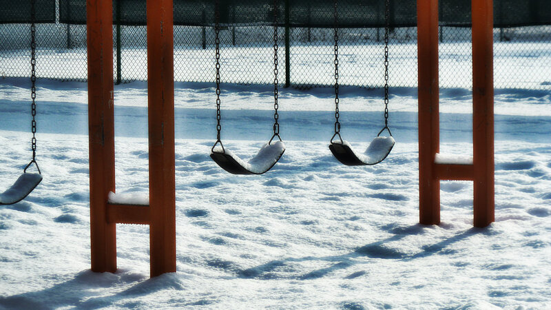 Snow-covered Swings