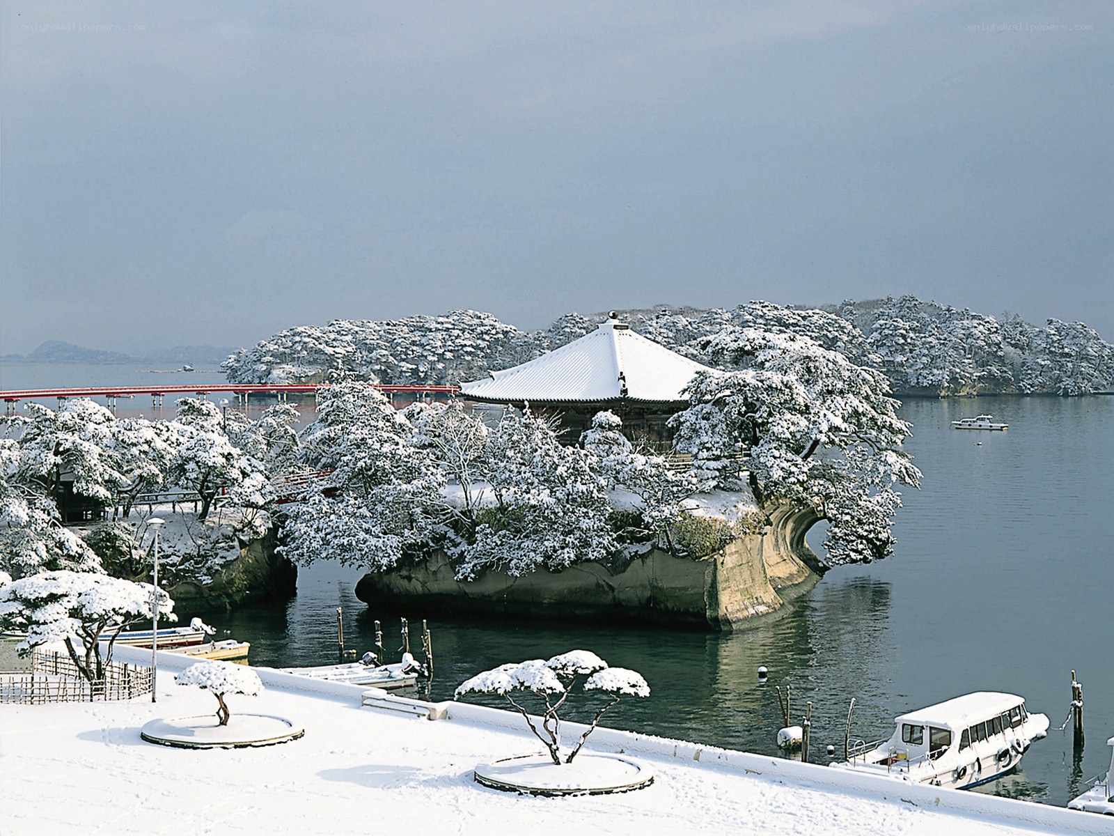 Snow-covered temple on a lake