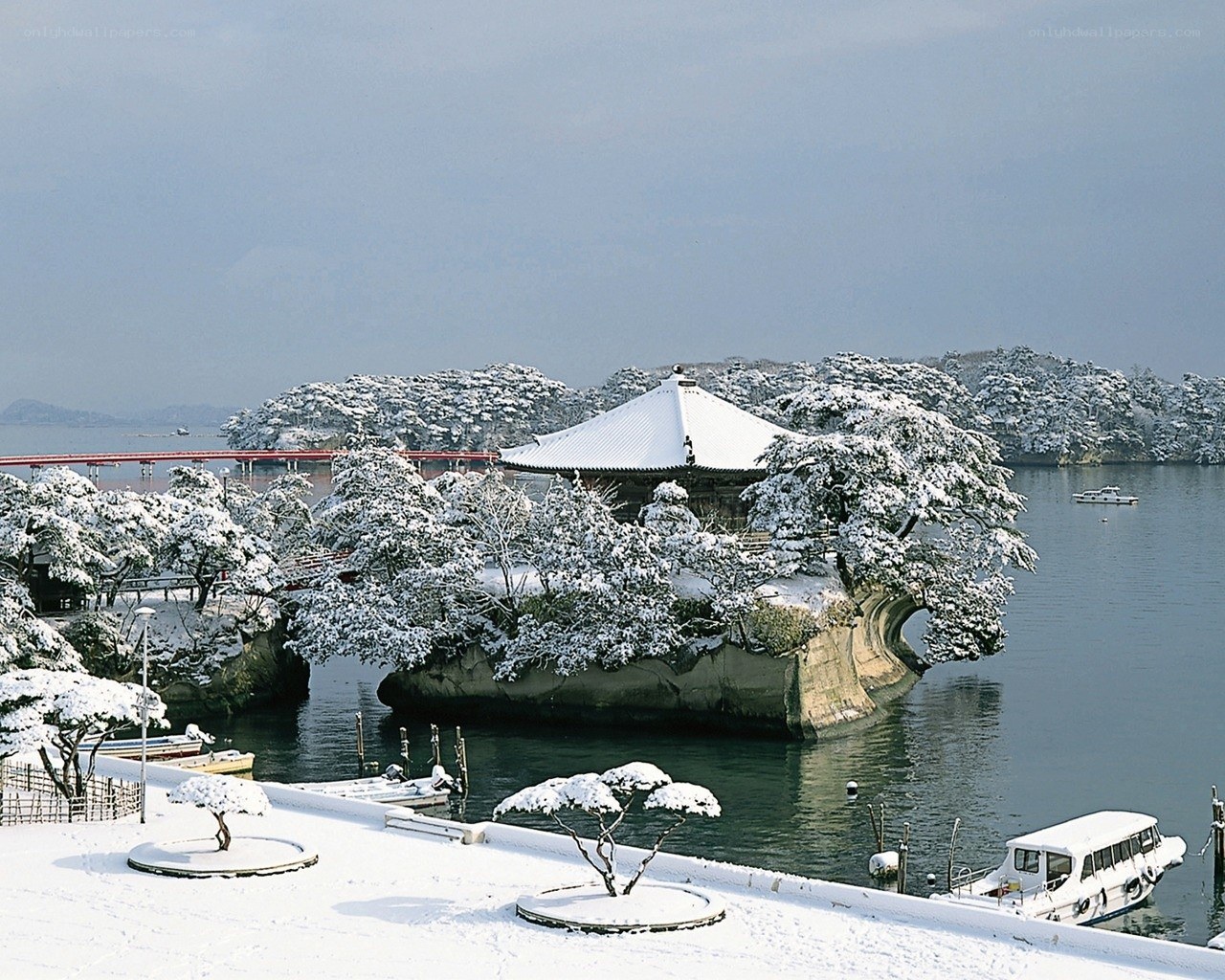 Snow-covered temple on a lake