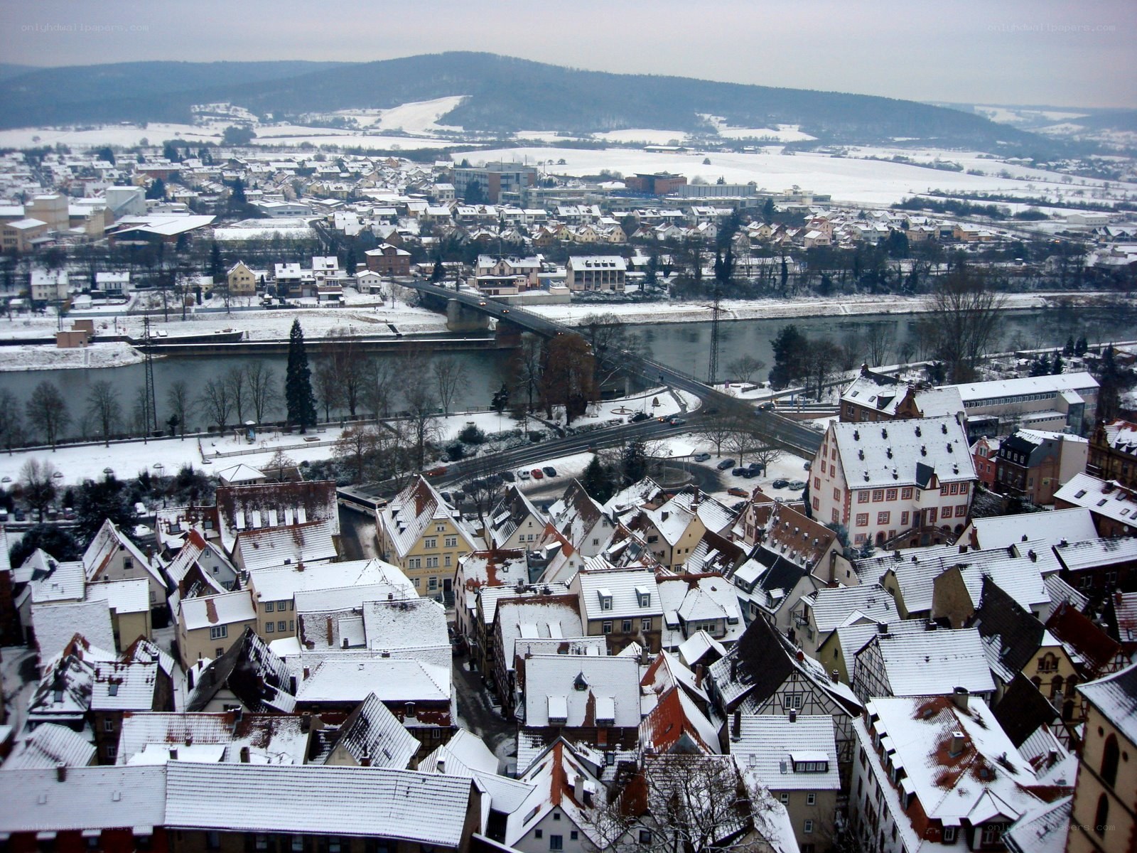 snow-covered town by river