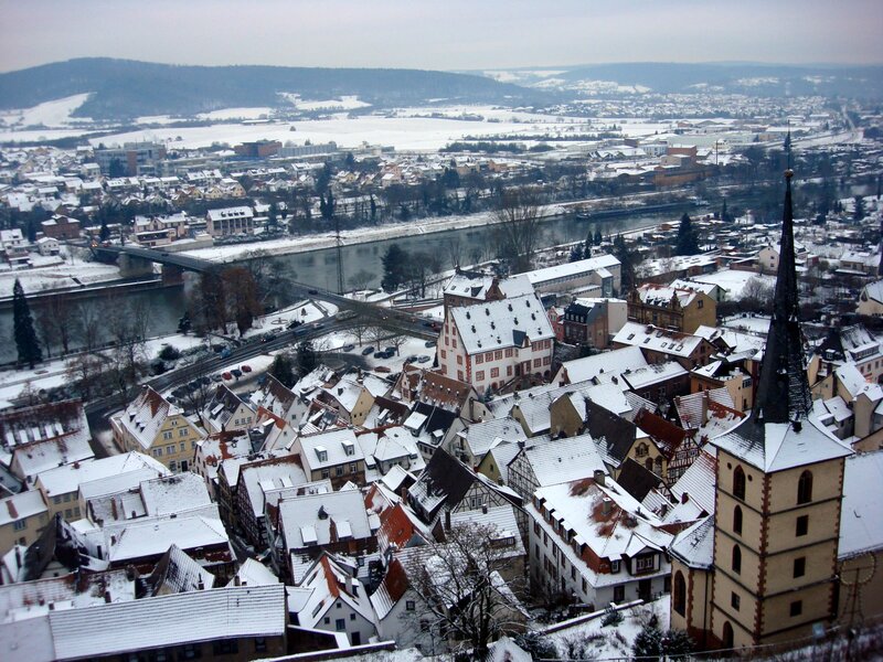 Snow-covered town by river