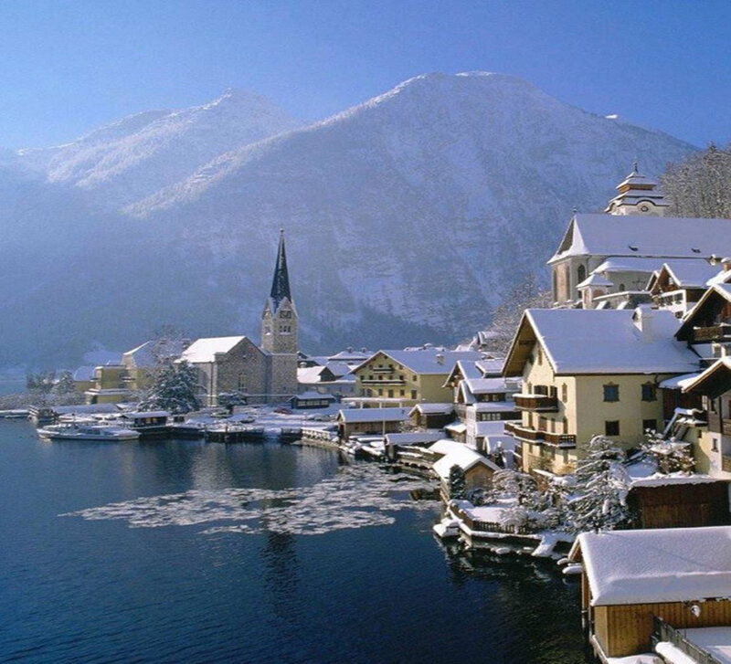 Snow-covered Village by Lake — Blue, Serene, Winter, Photograph, Mountains, Church