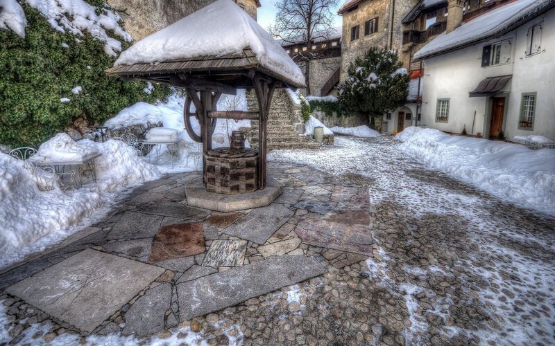 Snow-covered village well