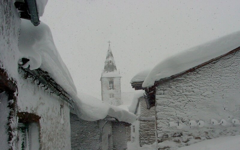 snow-covered village with church