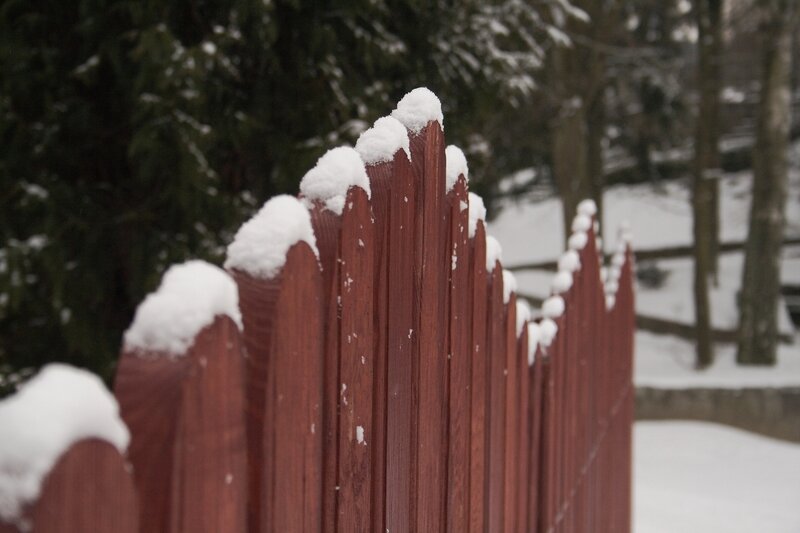 snow-covered wooden fence