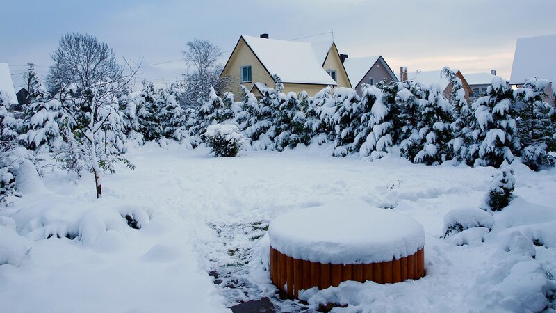 snow-covered yard with hot tub