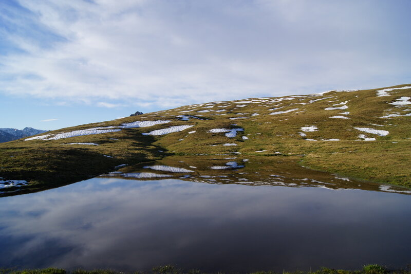 Snow-dotted Hillside Pond